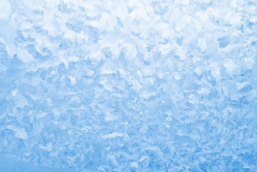 Light blue frozen window glass background