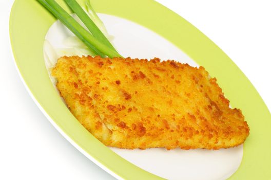 Breaded Сod Fillet Garnished with Spring Onion on Green Plate closeup