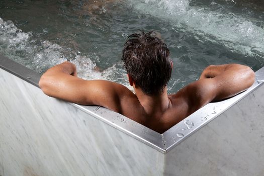 Man in bathtub in spa.