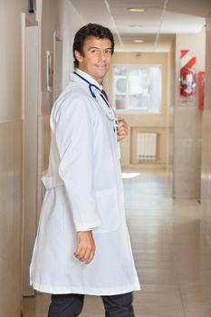 Portrait of a happy doctor at hospital corridor