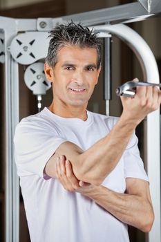 Portrait of mature man working out in fitness center