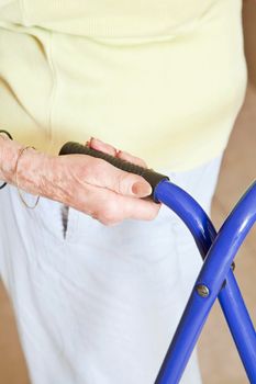 Close-up of elderly woman hand on zimmerframe.