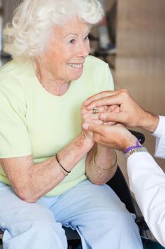 Doctor comforting happy senior woman