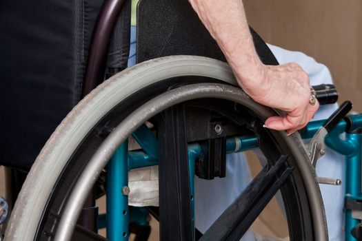 Close-up of Elderly Woman's Hands on wheelchair.