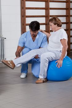 Male Physical therapist helping a patient.