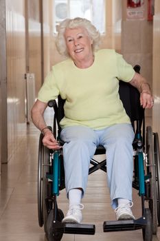 Retired woman on wheelchair at hospital.