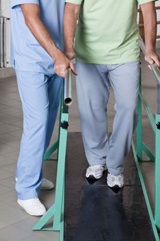 Senior man having ambulatory therapy with his therapist.