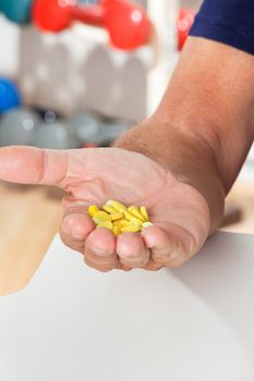 Close-up of senior man's hand holding tablets