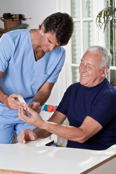 Doctor taking a blood sample from a male patient's.