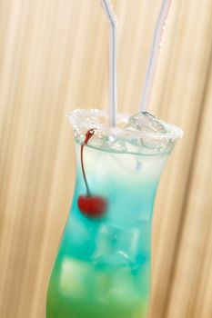 blue cocktail with cherry