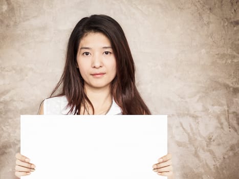 young asian woman holding blank sign