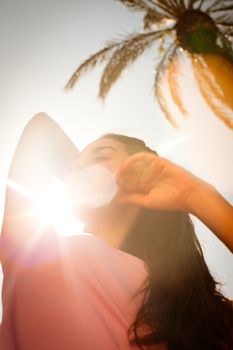 Young beautiful woman portrait with sun flare from above