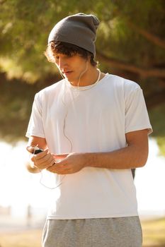 young handsome man consulting phone outdoors