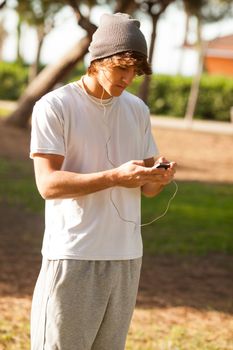 young handsome man consulting phone outdoors