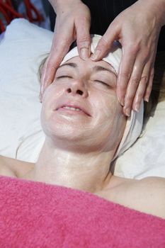 woman having a facial treatment in beauty salon