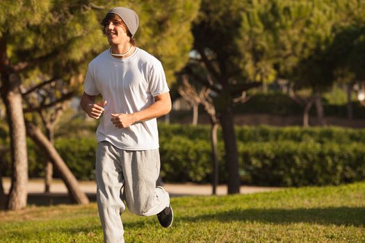 young handsome man jogging in public park