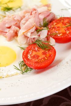 fried eggs with bacon and vegetables 