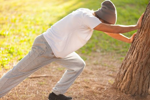 young man portrait stretching after jogging