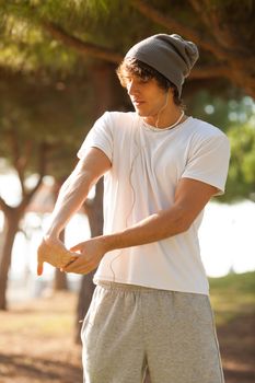 young man portrait stretching after jogging