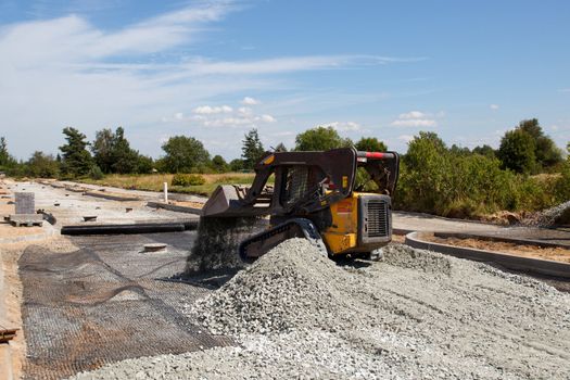small excavator working at construction of a new street