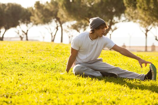 young man portrait stretching after jogging