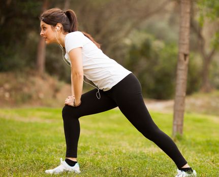 young beautiful woman stretching outdoors