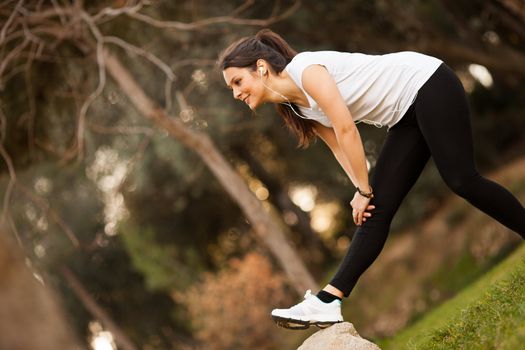 young beautiful woman stretching outdoors