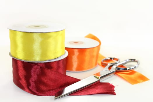 three rolls of ribbon in front of white background