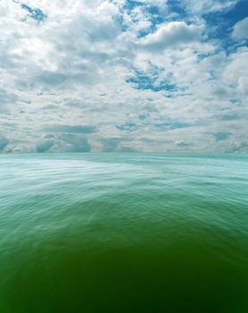 cloudy sky over sea with green tone