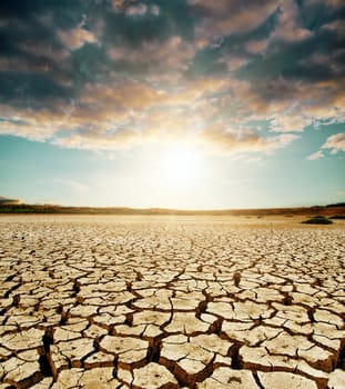 global warming. dramatic sky over cracked earth