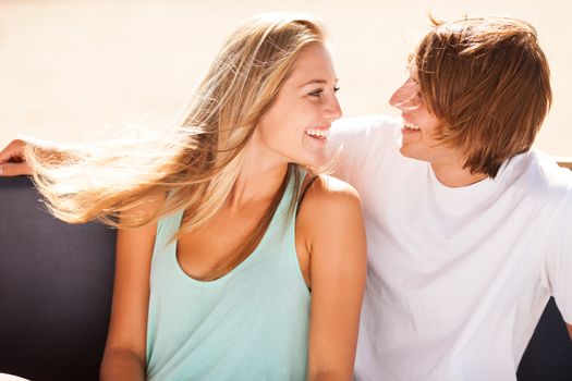 Young beautiful couple having fun in a beach bar