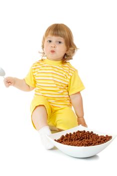 Small girl eat corn flakes isolated on white