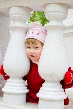 Little smiling gril with marble columns
