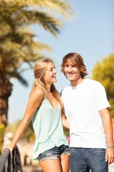 Young romantic beautiful couple enjoying on a walkside with threes