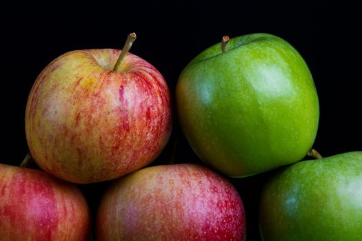 Apples in a row on black backround