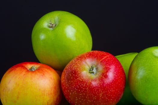 Apples in a row on black backround