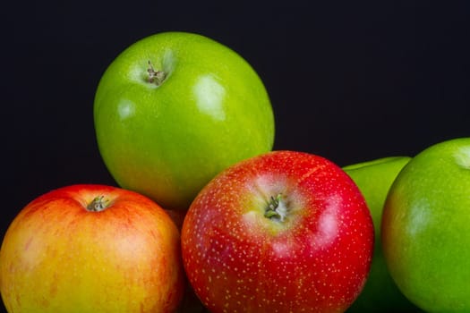 Apples in a row on black backround