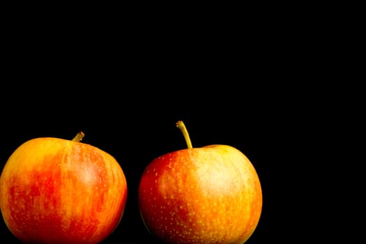 Apples in a row on black backround