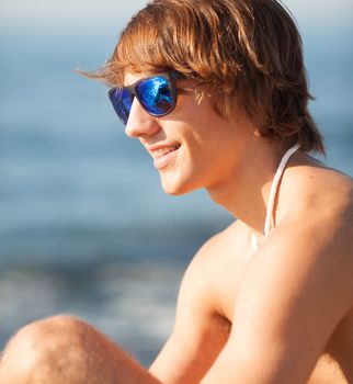 young healthy beautiful men portrait laughing on the beach