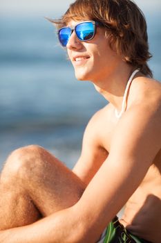 young healthy beautiful men portrait laughing on the beach