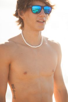 young healthy beautiful men portrait laughing on the beach