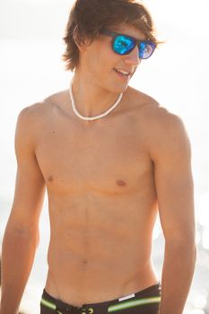 young healthy beautiful men portrait laughing on the beach