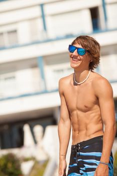 young healthy beautiful men portrait laughing on the beach