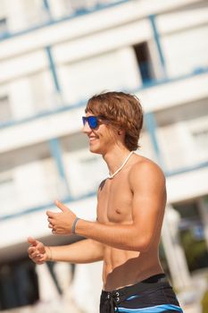 young healthy beautiful men portrait laughing on the beach