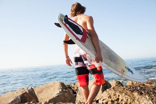 young surfer about to get into the sea