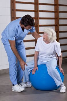 Male Physical therapist helping a patient.