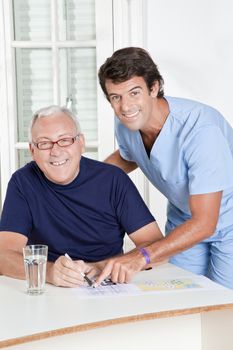 Portrait of mature man playing sudoku puzzle.