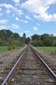 Train tracks cutting through the mountains of North Carolina near Asheville on a sunny day.