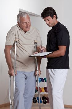 Patient on crutches discusses his progress.