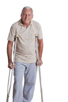 Senior man with crutches and females doing physical exercise .